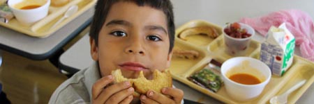 Student enjoying school lunch.