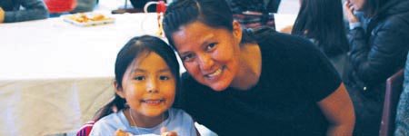 Mother and daughter smiling for camera